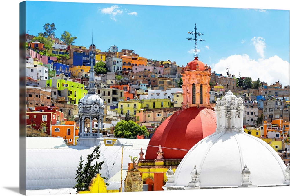 Photograph of a Guanajuato, Mexico, cityscape displaying colorful buildings, homes, and church domes. From the Viva Mexico...