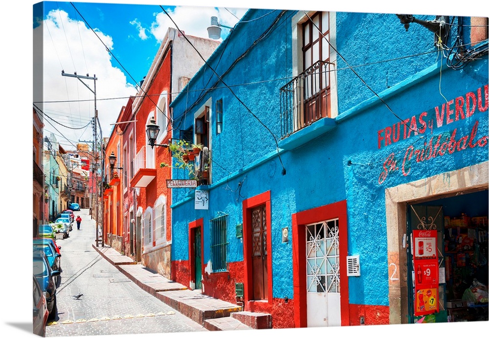 Colorful streetscape photograph in Guanajuato, Mexico with bright blue and red buildings. From the Viva Mexico Collection.