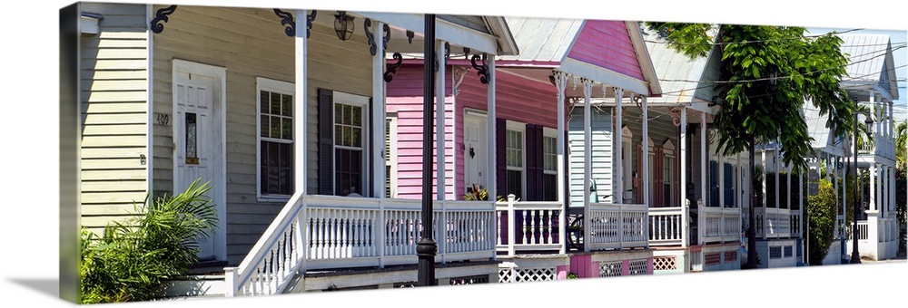 A row of classic houses in Key West, with one house painted bright pink.
