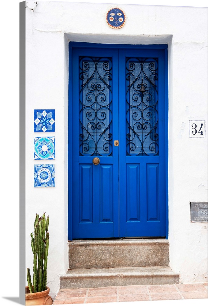 It's an old blue door on a white wall in Mijas, Spain.