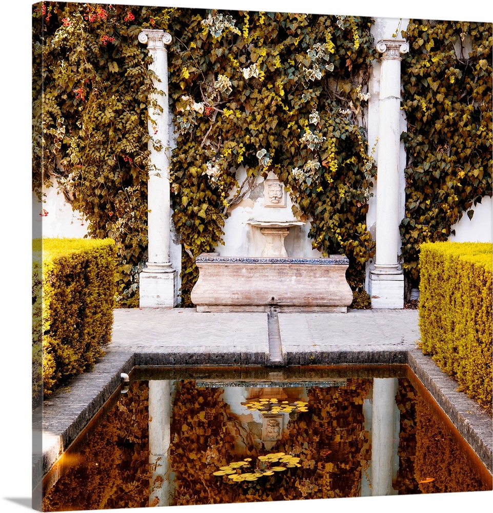 It's an old fountain with fall colors in the Alcazar gardens in Seville, Spain.