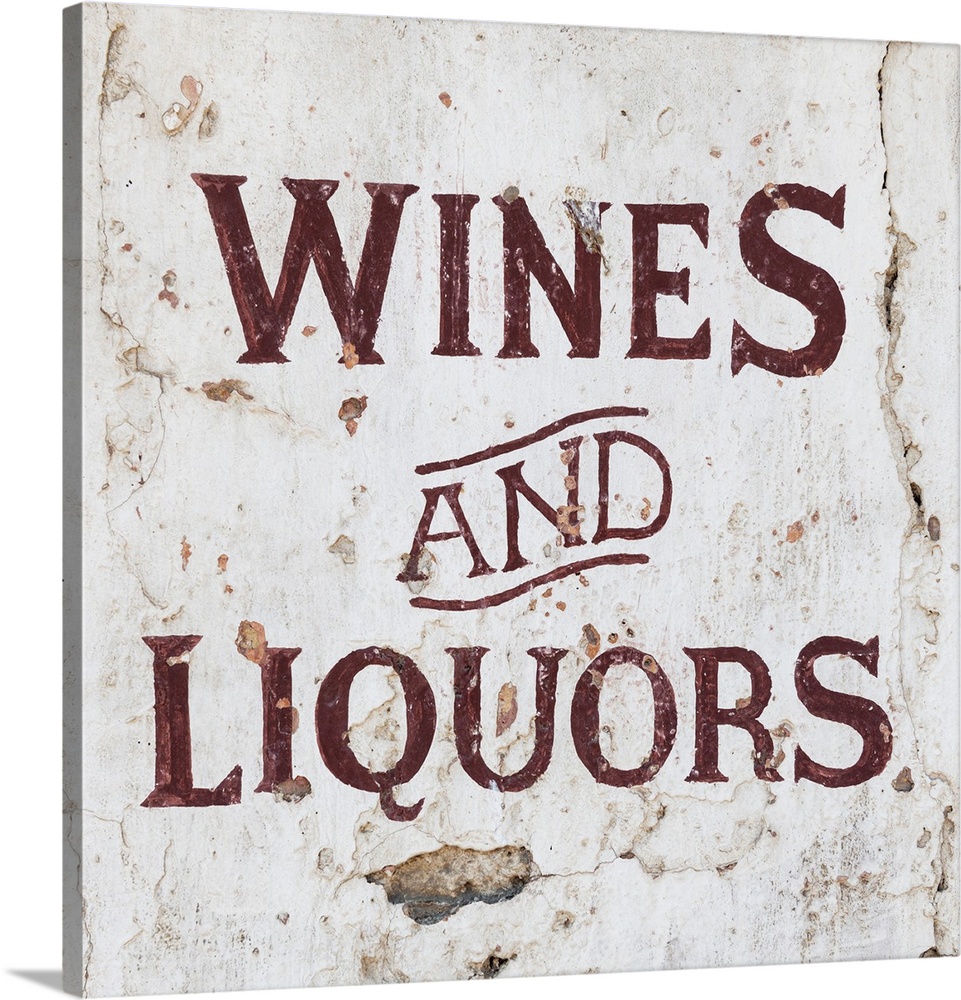 It's a Wines and Liquors sign on an old wall, Spain.