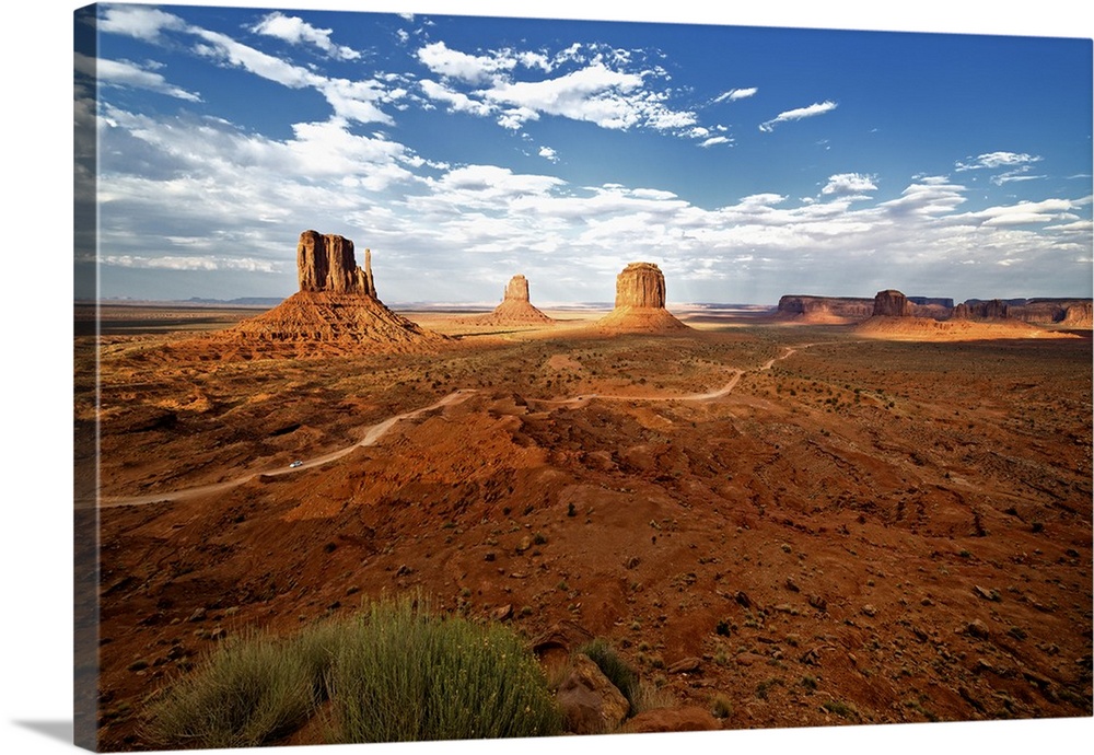 Large rock formations in the desert landscape of Monument Valley.