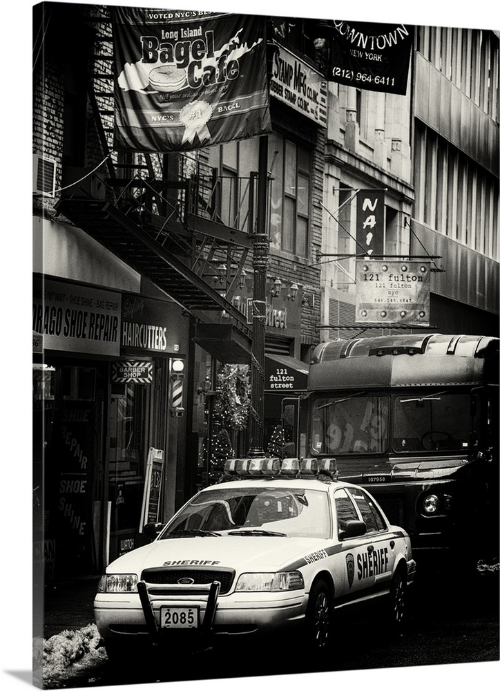 A black and white photograph of an NYPD police car in New York city.