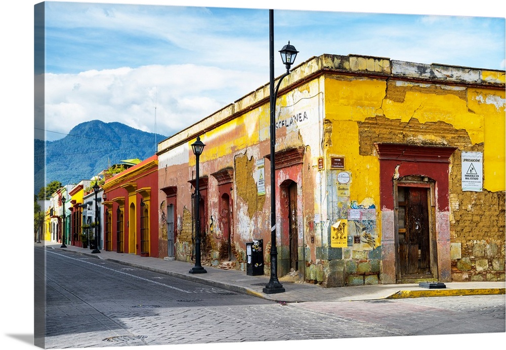 Photograph of a bright city street in Oaxaca, Mexico, with a view of mountains in the background. From the Viva Mexico Col...