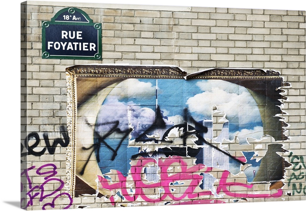 Graffiti on a poster and brick wall in Montmartre, the 18th municipal arrondissement in Paris.