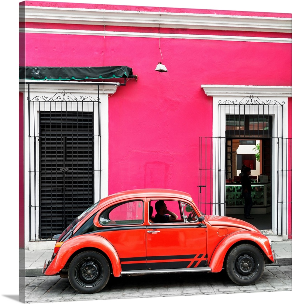 Square photograph of a classic red Volkswagen Beetle parked in front of a pink building. From the Viva Mexico Square Colle...