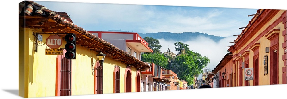 Panoramic photograph of a streetscape at San Cristobal de Las Casas in Chiapas, Mexico, with heavy fog in the background. ...