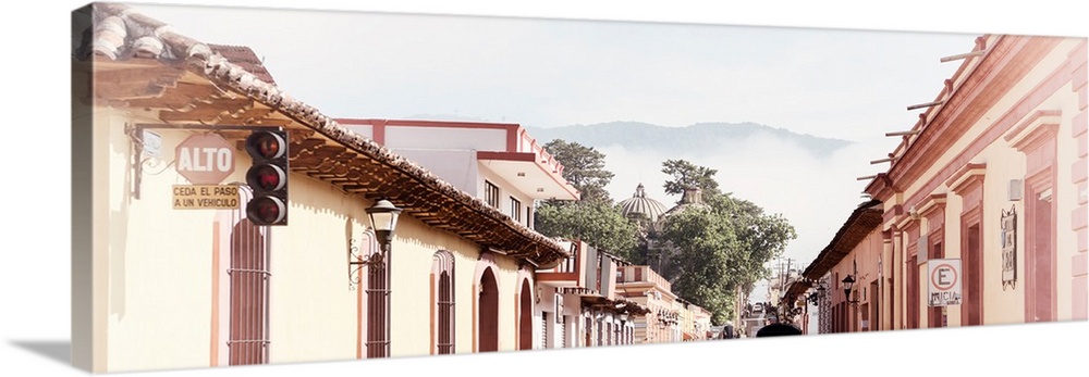 Washed out panoramic photograph of a streetscape at San Cristobal de Las Casas in Chiapas, Mexico, with heavy fog in the b...