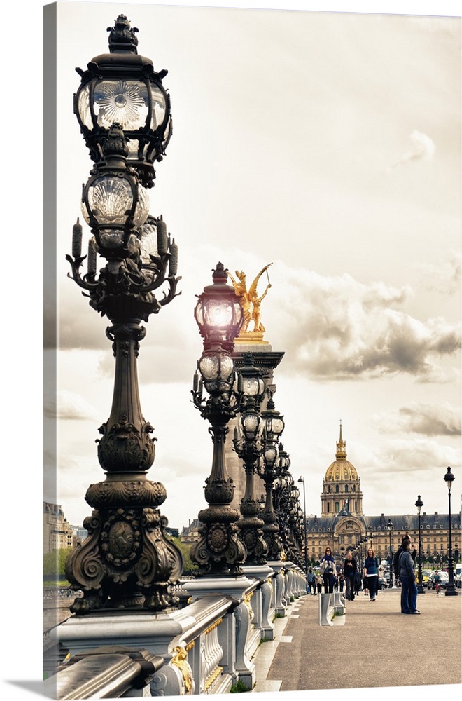 Row of detailed iron street lamps on the Pont Alexandres III in Paris, France.