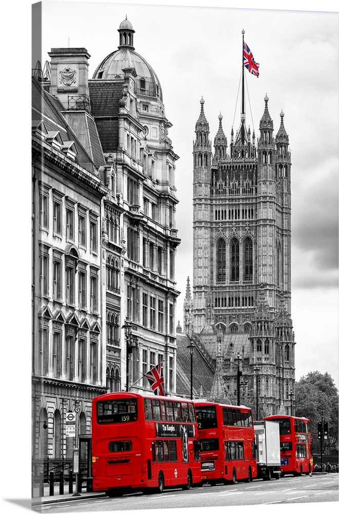 Row of double decker buses on the street by the House of Parliament in London, England.