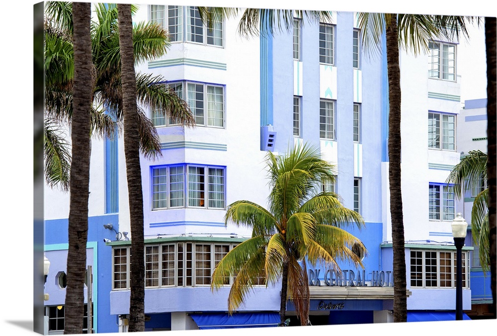 Palm trees frame the blue Art Deco architecture of the Park Central Hotel in Miami Beach.