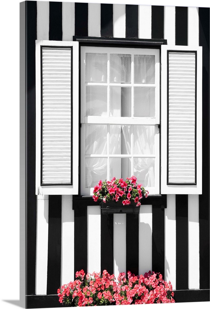Its' a window of a typical house with black and white stripes at Costa Nova Beach, Portugal.