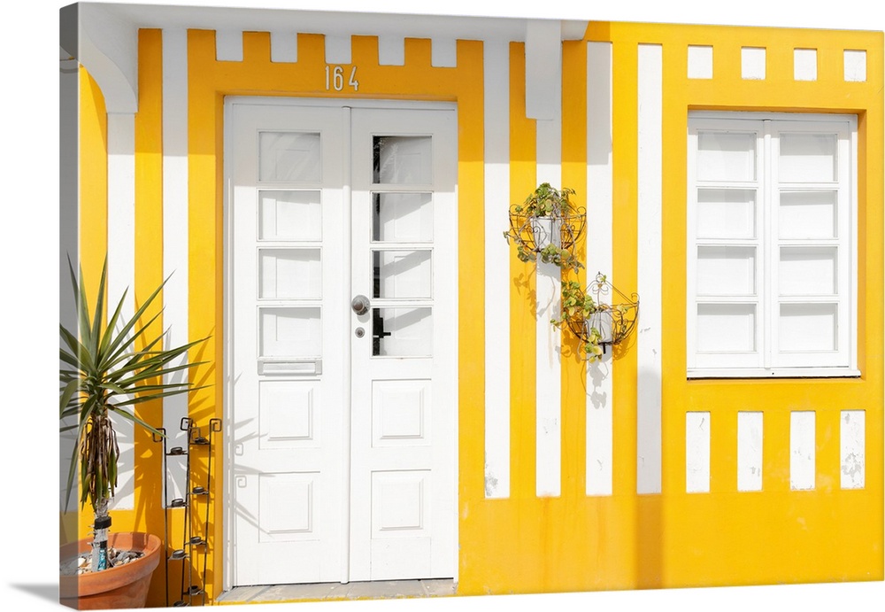 It's a facade with yellow stripes of traditional house in costa Nova beach in Portugal.