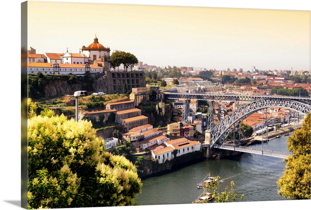 It's a landscape picture of the city of Porto (Portugal) at sunset, with the Douro River and the Dom Luis bridge.