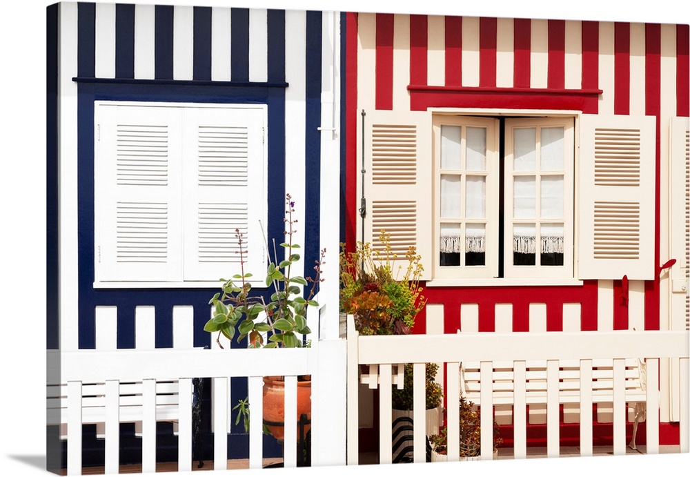 These are two colourful striped facades of traditional houses at Costa Nova Beach in Portugal.