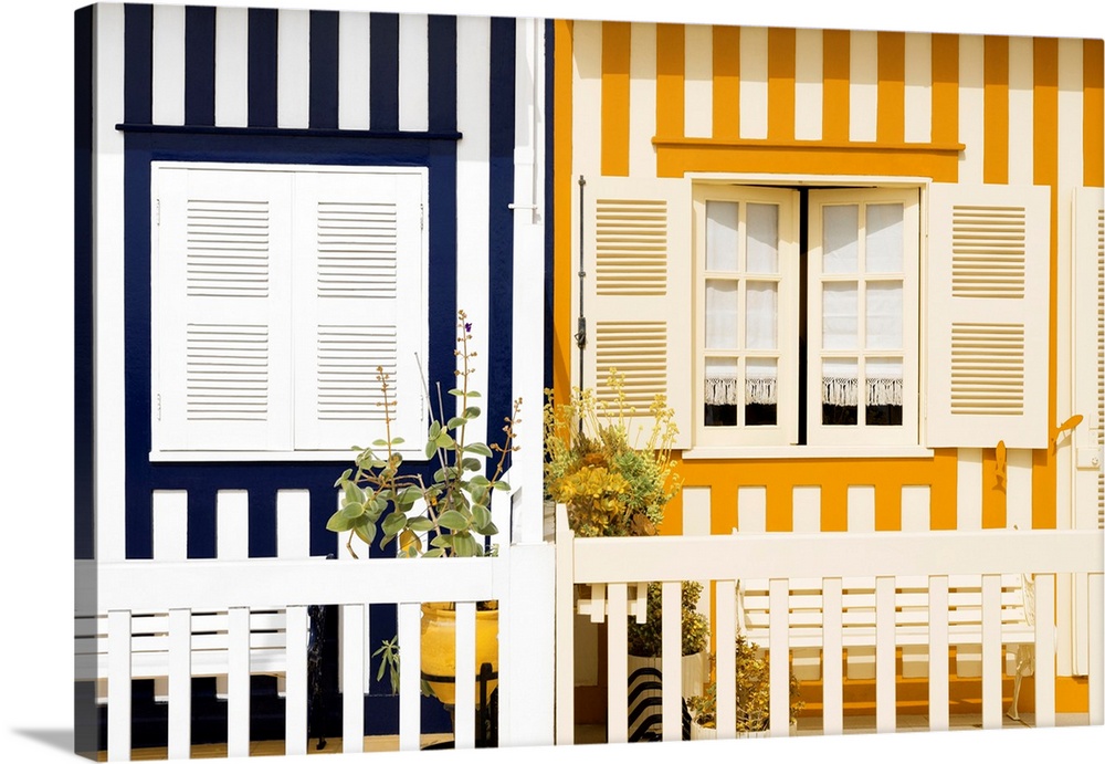 These are two colourful striped facades of traditional houses at Costa Nova Beach in Portugal.