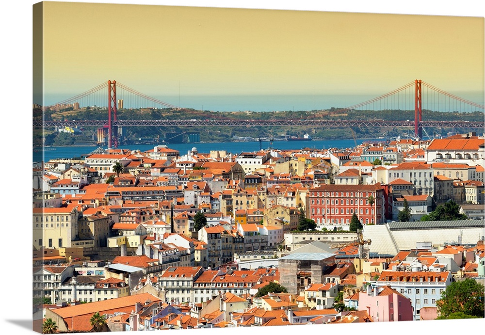 It's a view of the city of Lisbon at sunset with the 25 de Abril bridge in Portugal.