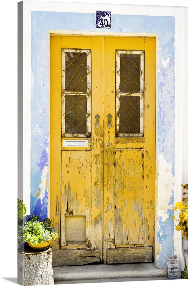 It's an old yellow door entrance to a traditional house in Portugal.
