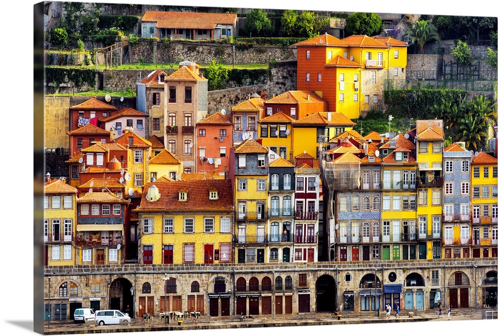 This is a view of the Ribeira district in Porto on the banks of the Douro river at sunset with the magnificent colorful fa...