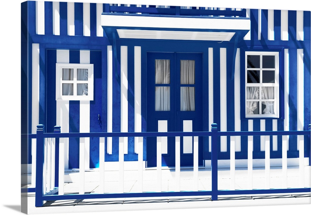 It's a tradional white house facade with royal blue stripes in Costa Nova Beach, Portugal.