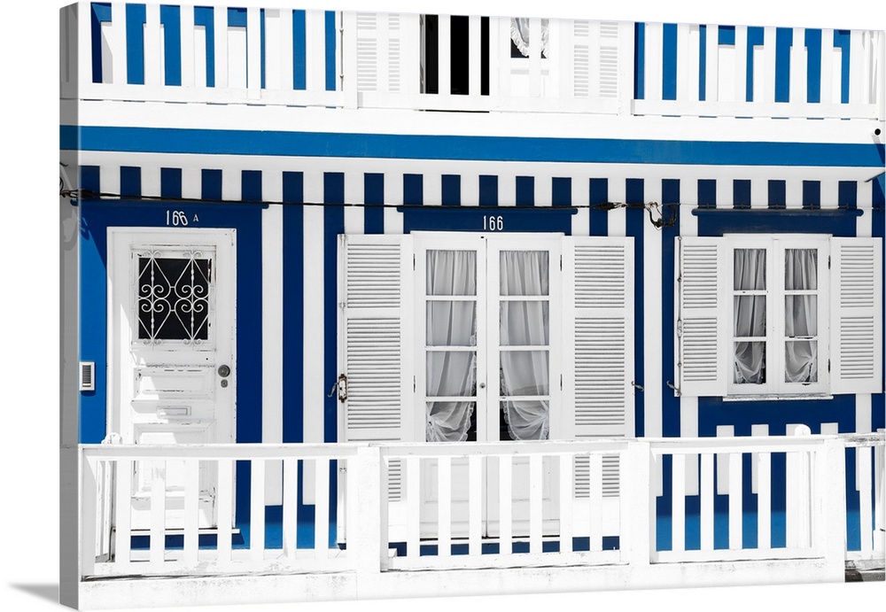 It's a typical white house facade with blue stripes in Costa Nova Beach, Portugal.