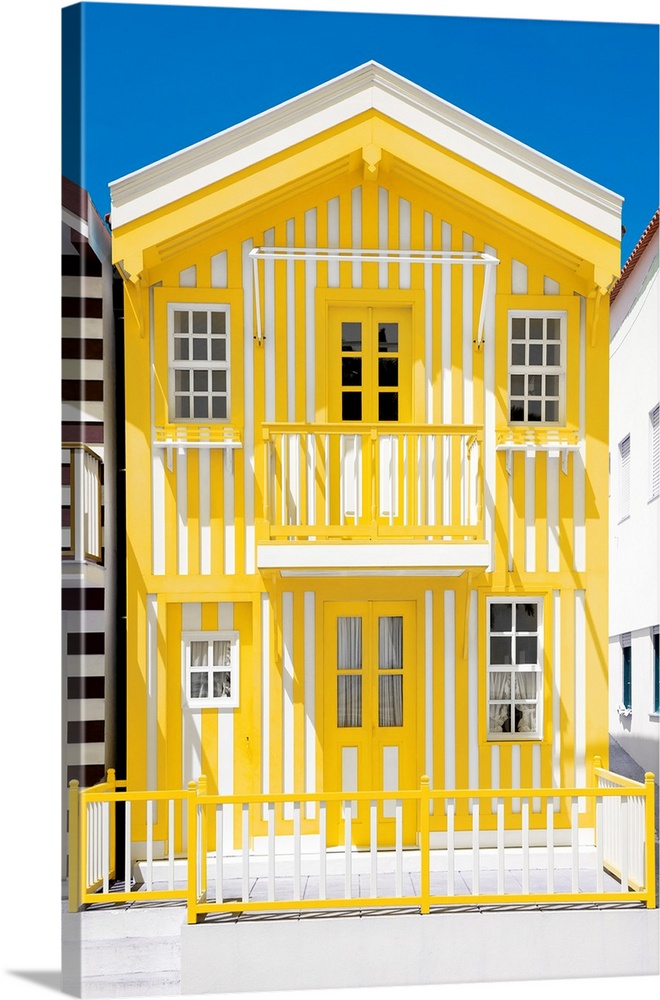 Its' a typical house with yellow stripes in Costa Nova Beach, Portugal.