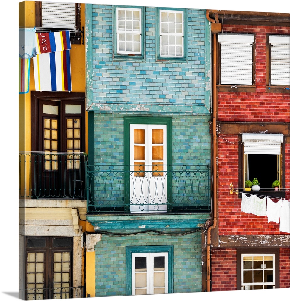 These are typical colourful facades with hanging linen in the Ribeira district of Porto (Portugal).