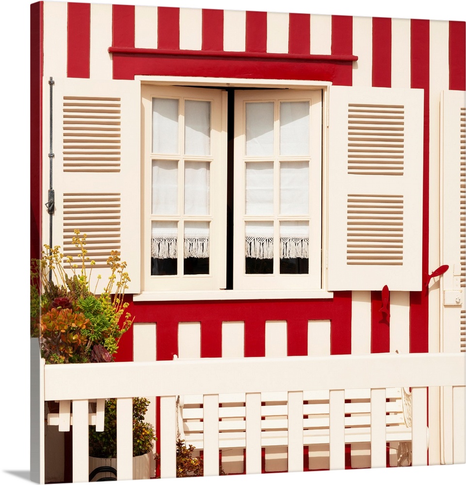 Its' a traditional window with red stripes at Costa Nova Beach in Portugal.