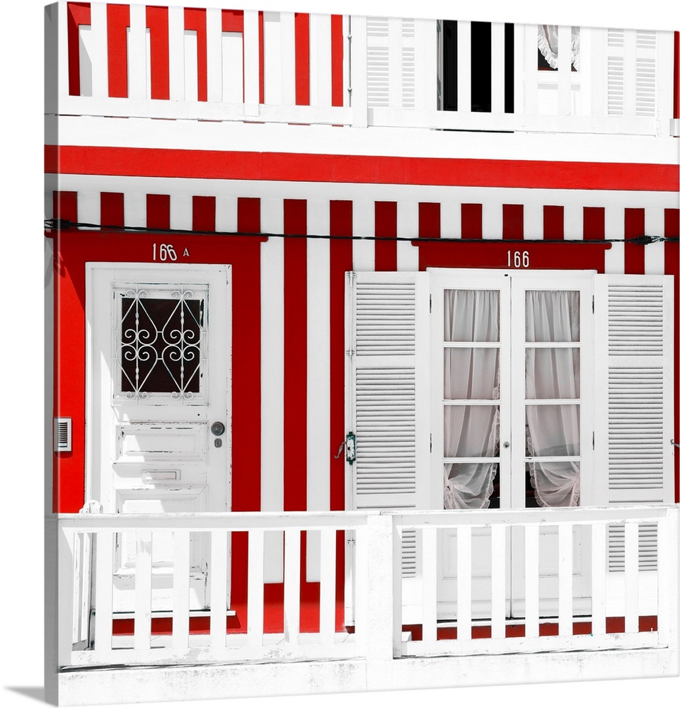 It's a typical white house facade with red stripes in Costa Nova Beach, Portugal.