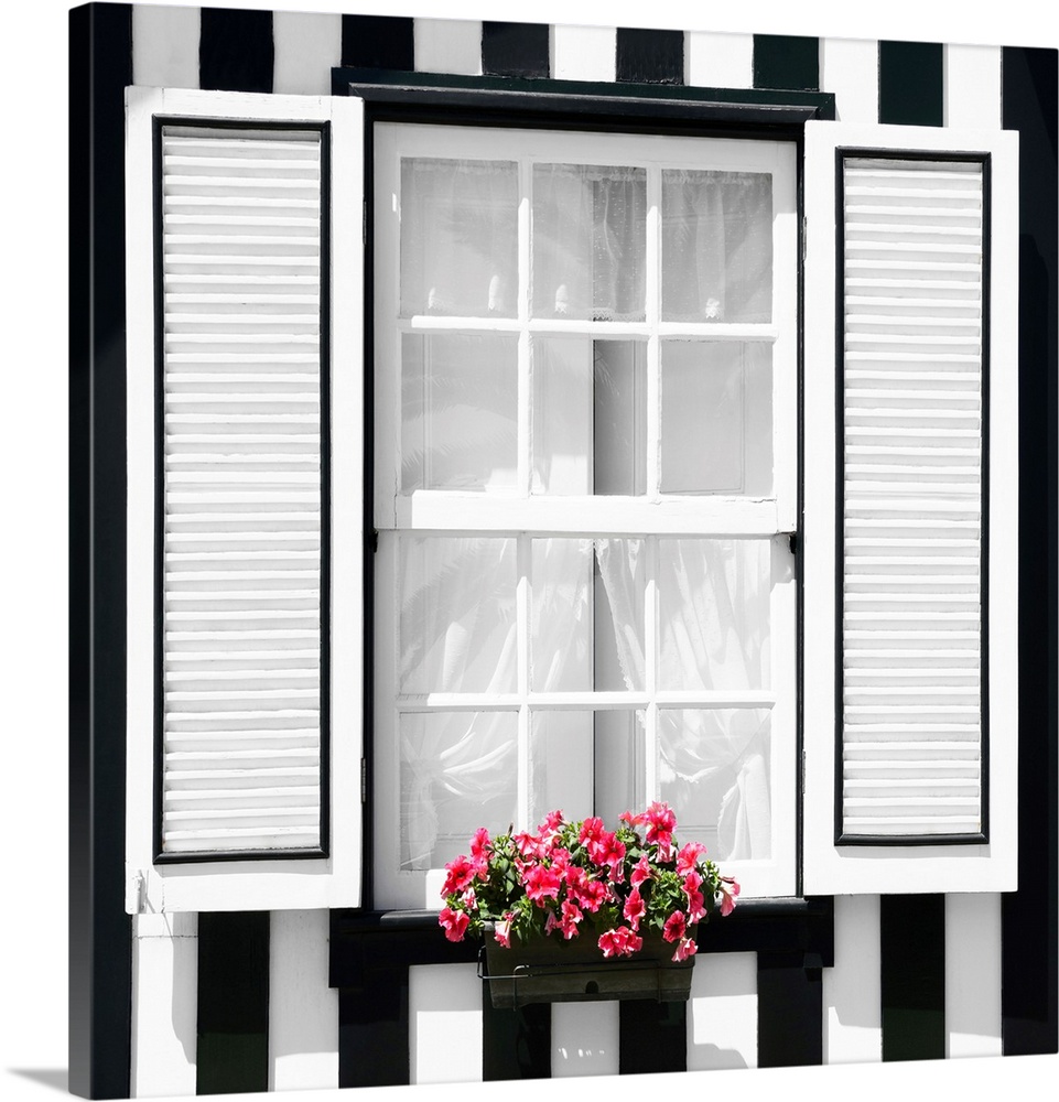 It's a window of a typical house with black and white stripes at Costa Nova Beach, Portugal.