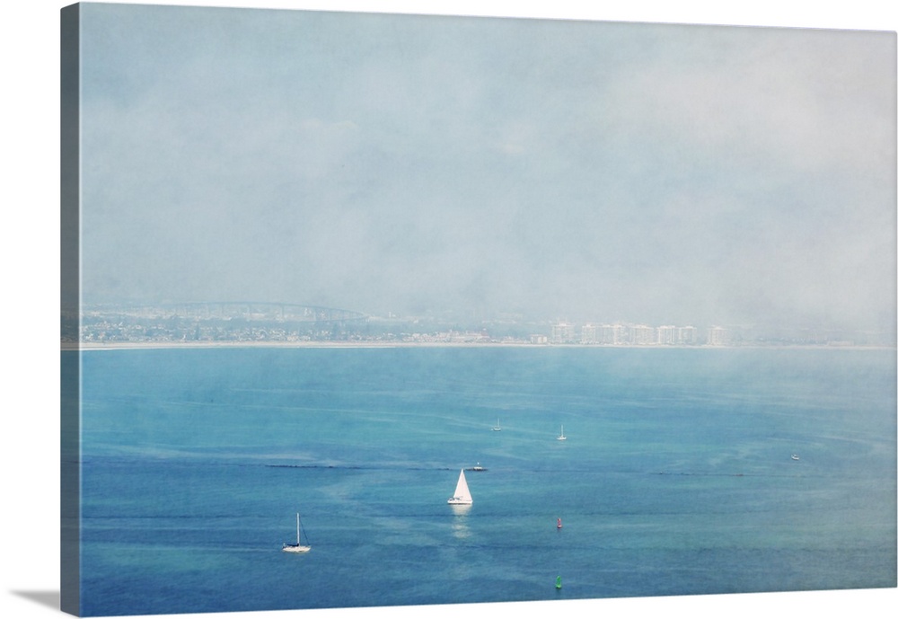 White sailboats on the deep blue ocean off the coast of Coronado, California.