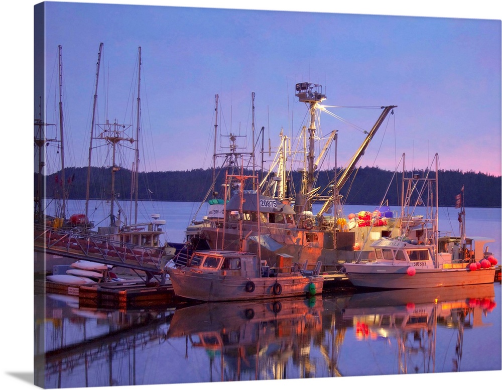 Pictorialist photo of fishing boats reflected in the water while docked.