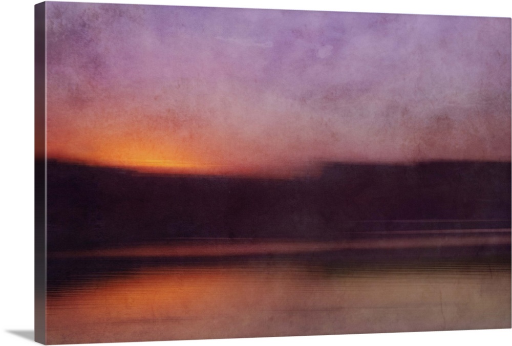 Photograph of a cove surrounded by silhouetted land forms with a sunset illuminating the sky in purple.