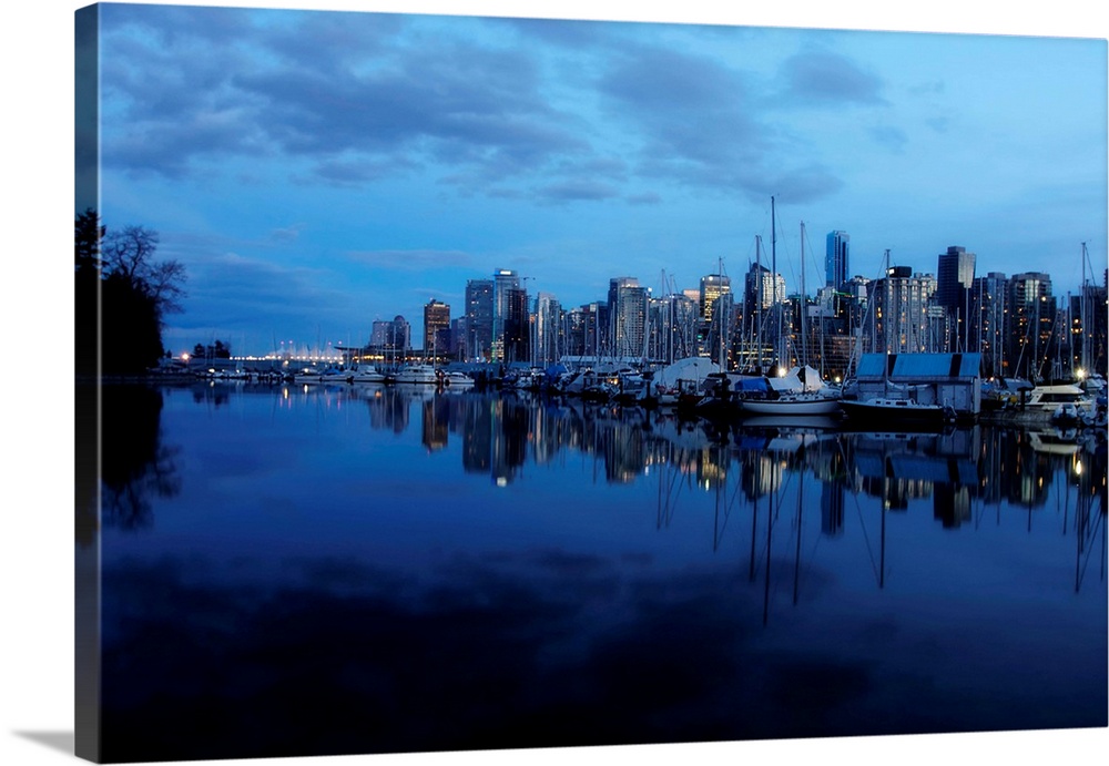 A pretty view of the Vancouver yacht club and downtown skyline at night.