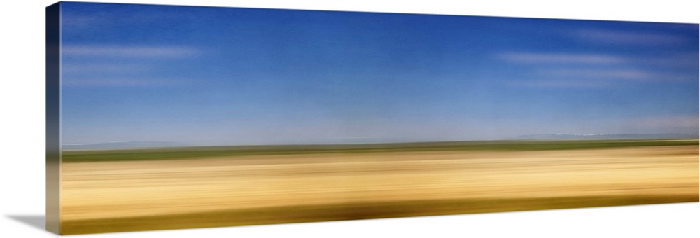 Photograph of golden western plains looking as if they're rushing by.