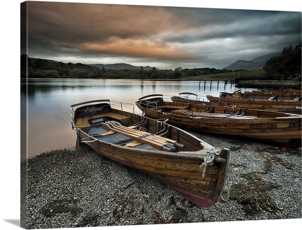 A row of wooden boats on the shore at Keswick, Cumbria.