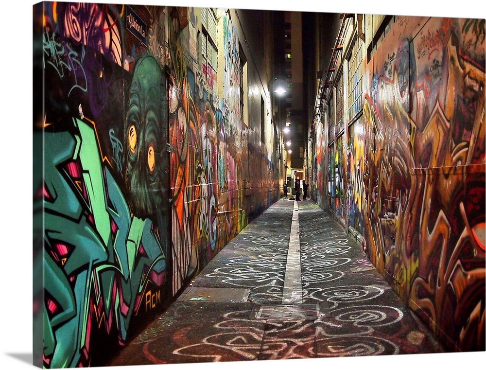 Photograph of an alley with its walls covered in graffiti.