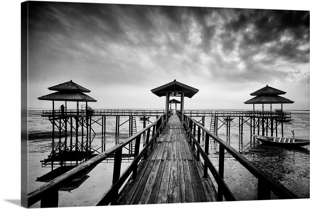 Black and white photo of a wooden pier in Kenji Beach, East Java, Indonesia.