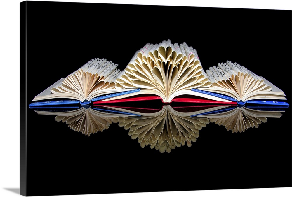 Three open books with pages folded into the shapes of hearts.