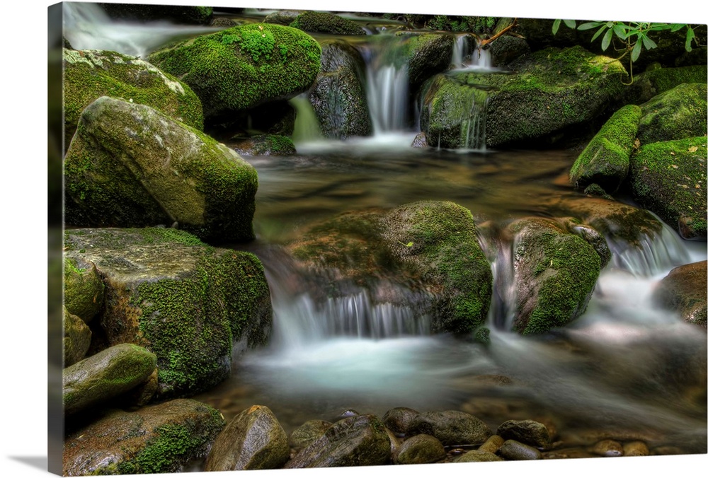 Several small waterfalls over mossy rocks in Deep Creek, North Carolina.