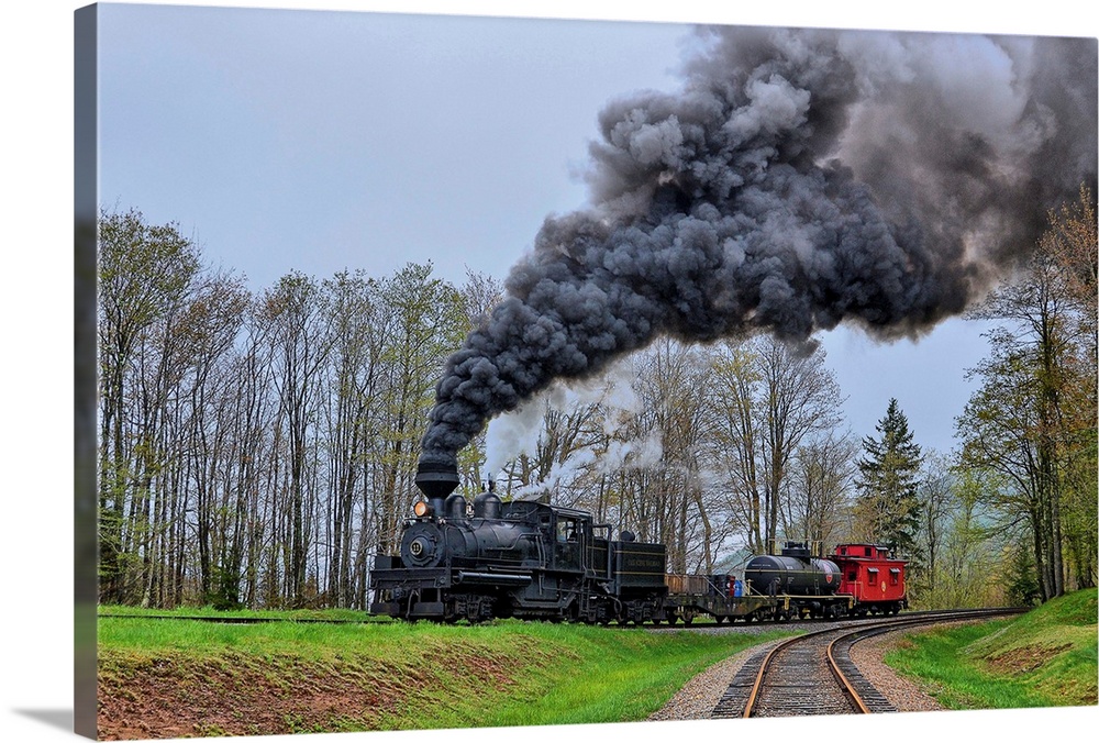 A locomotive with billowing black smoke climbs up a hill.