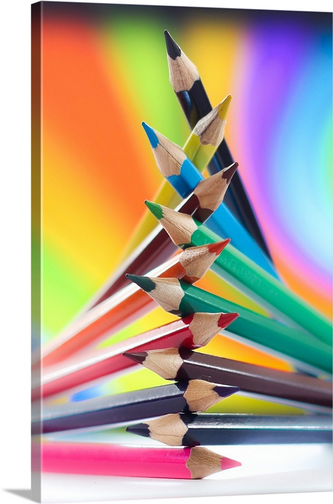 Colored pencils arranged in a pile, with rainbow colors.
