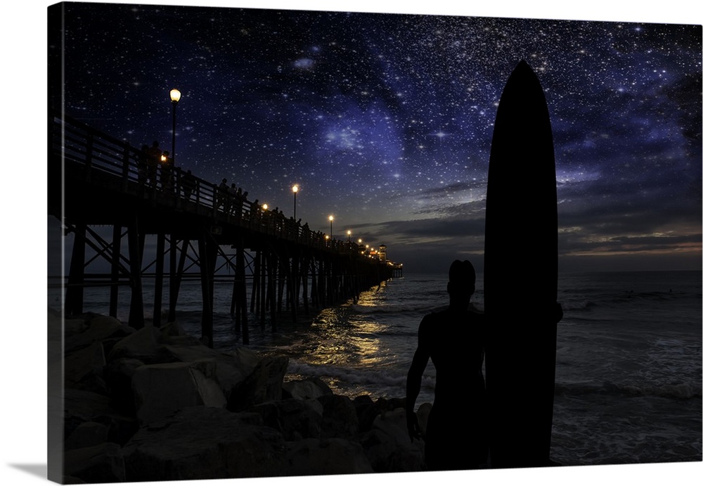 A silhouetted long board surfer watches the stars and dreams of big waves near the Oceanside Pier. Oceanside is 40 miles n...