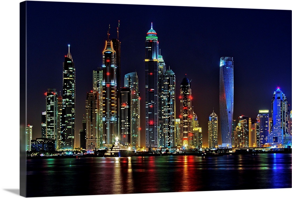Dubai skyline at night lit up in neon lights.