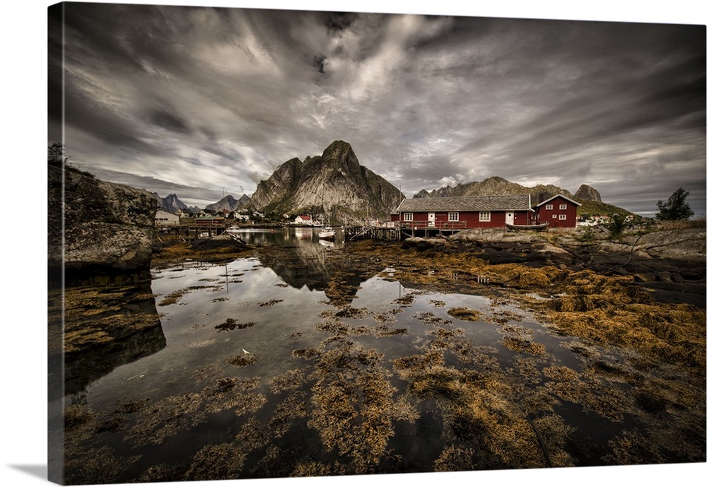 Dynamic photograph of a fishing village under cloudy skies.