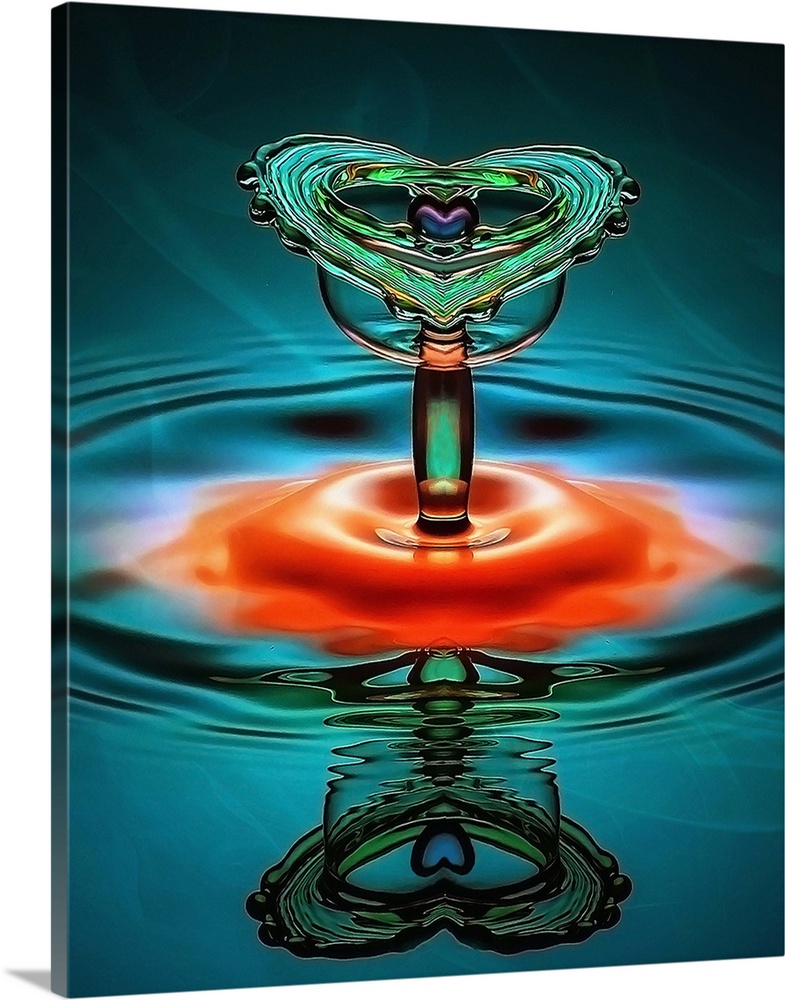 A droplet of liquid forms a heart shape as it splashes into the water.