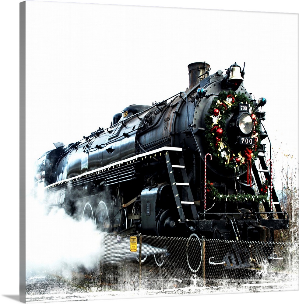 A black locomotive with a festive wreath on its nose.
