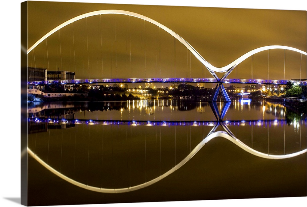 The arches of the Infinity Bridge in Thornaby-on-Tees in England, reflected in the water below.