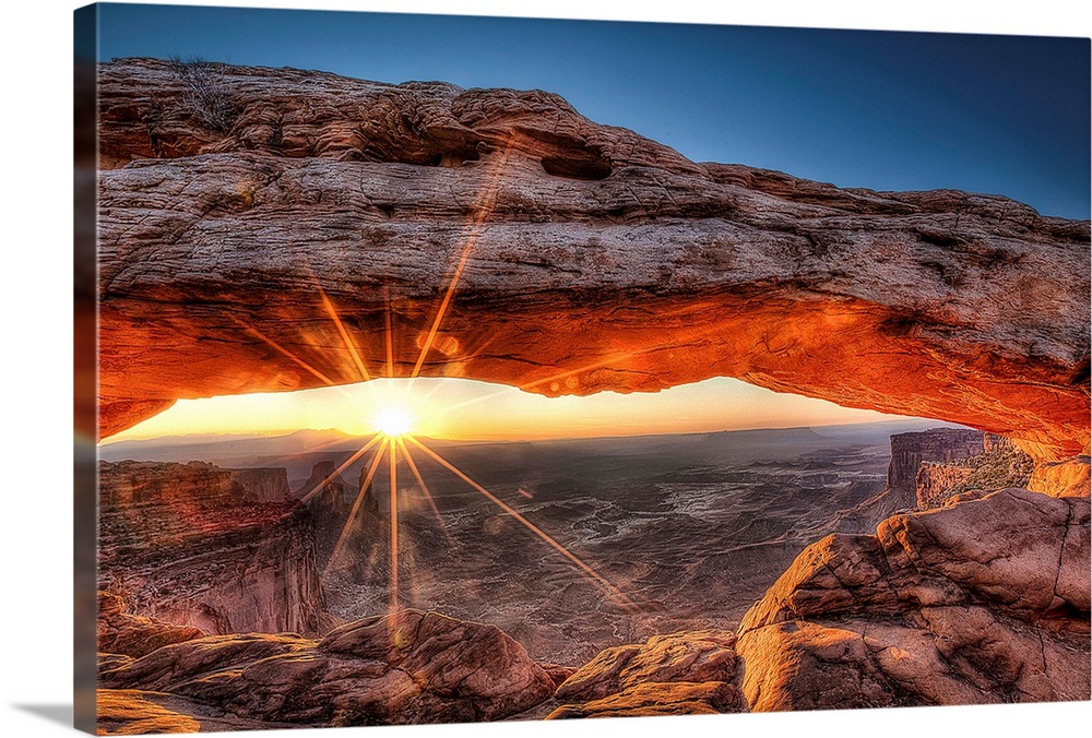 The sun rises in Canyonlands National Park and for a brief moment illuminates the breathtaking Mesa Arch.